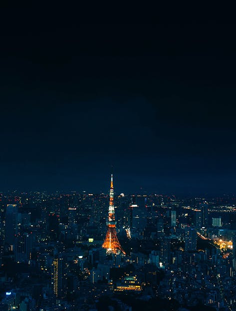 Views of the Tokyo Tower at night, with the neighbouring and sprawling city of Tokyo