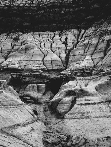 Black and white image of a rock formation with striations forming an intricate pattern in Wyoming, USA 