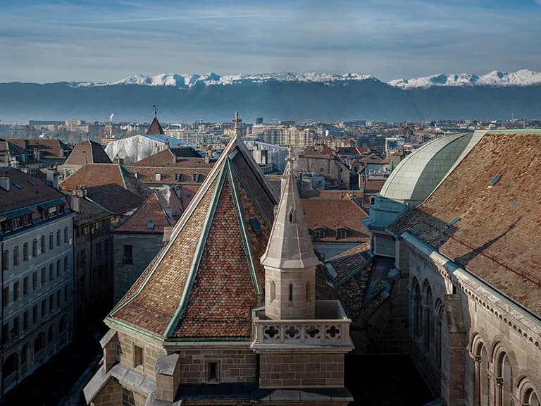 View across Geneva skyline to Swiss mountain range View across Geneva skyline to Swiss mountain range